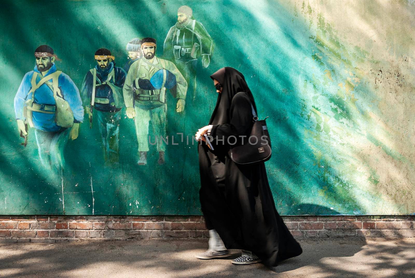 revolutionary fighters mural in downtown tehran city street iran by jackmalipan