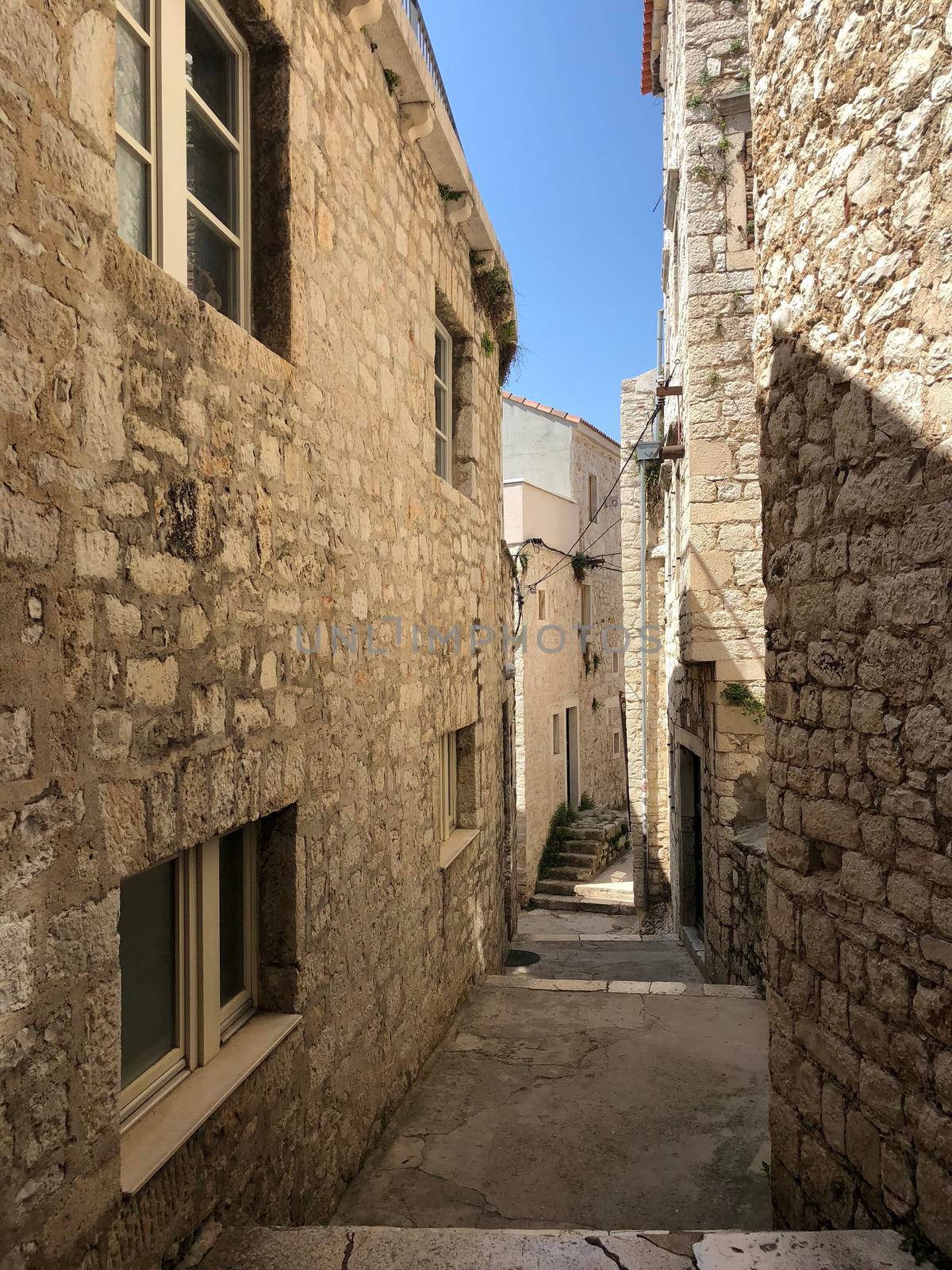 Alley in the old town of Sibenik by traveltelly