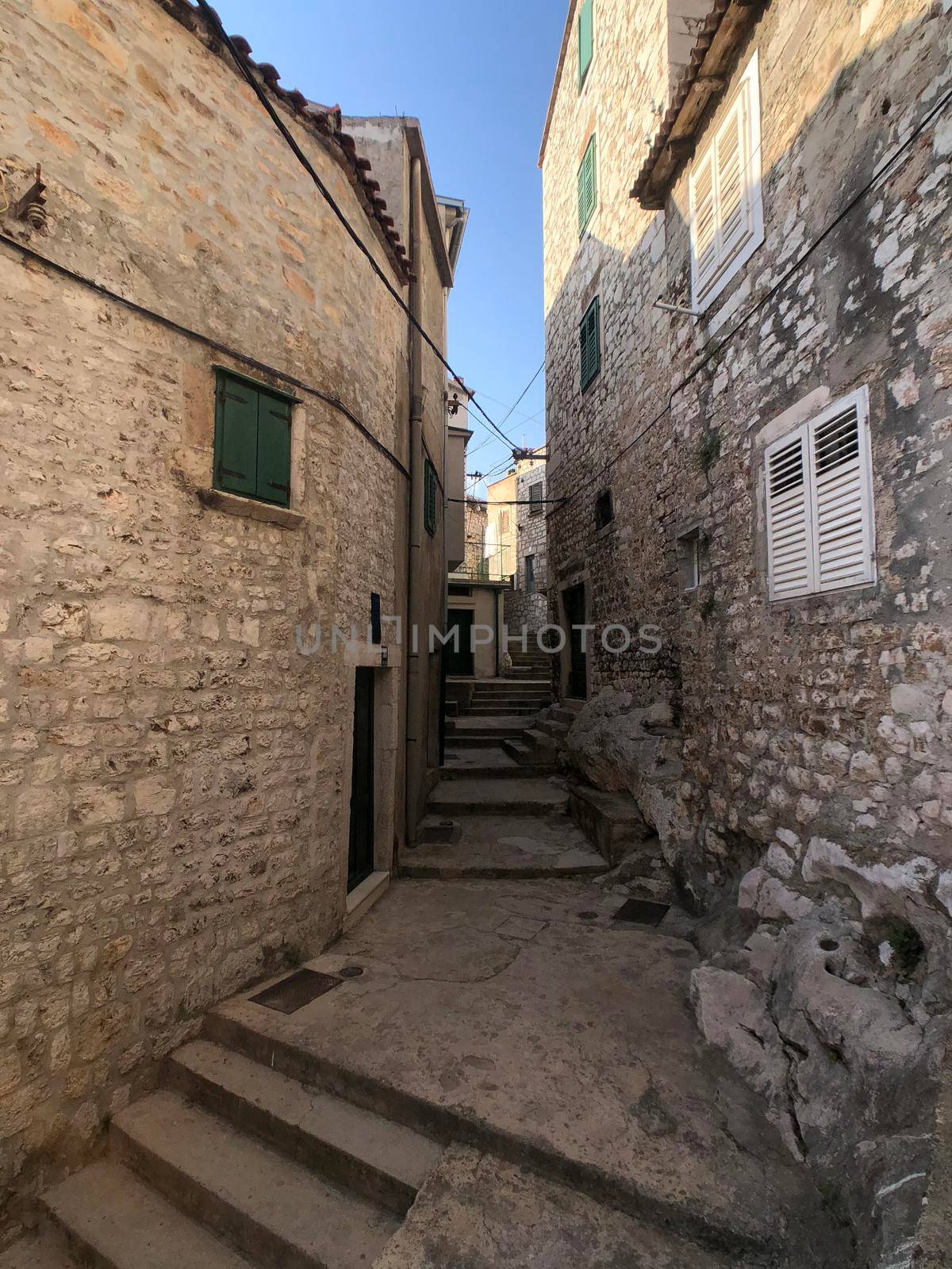 Alley in the old town of Sibenik by traveltelly