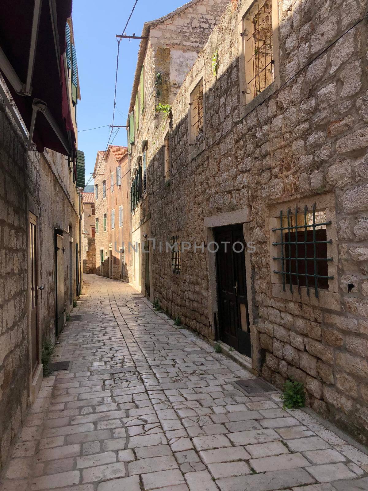 Street in the old town of Stari Grad by traveltelly