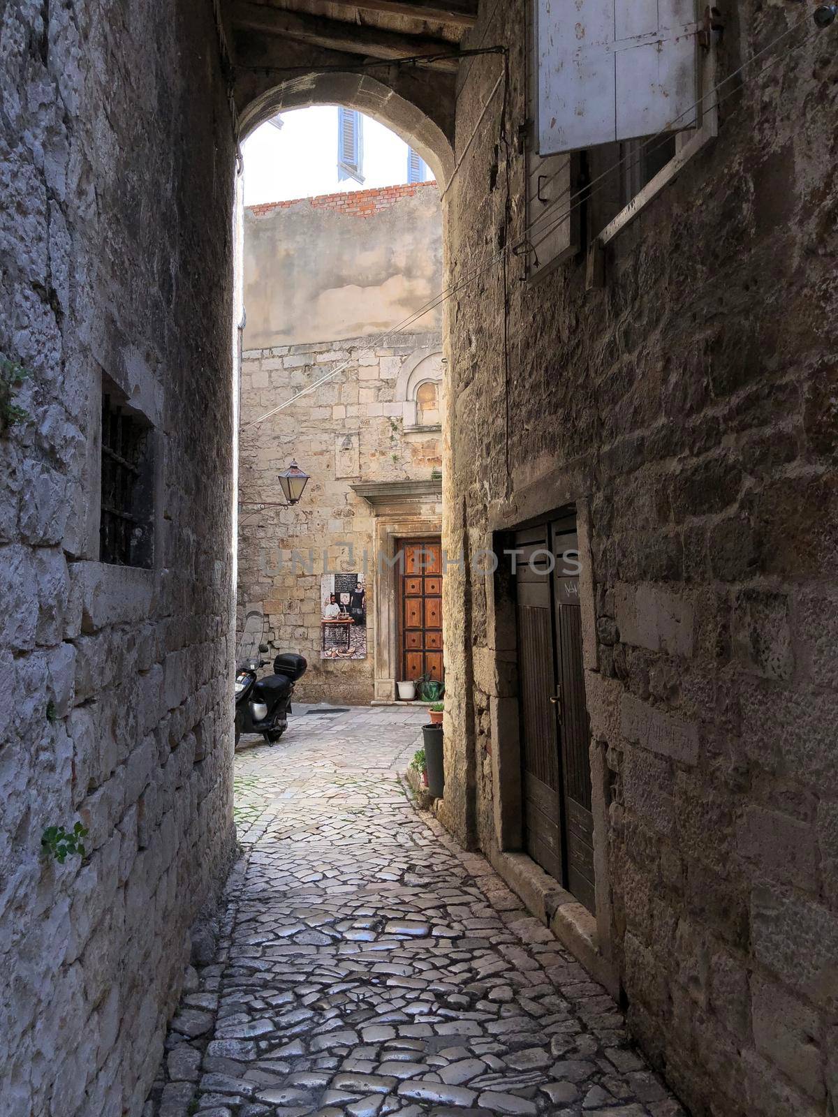 Alley in the old town of Trogir by traveltelly