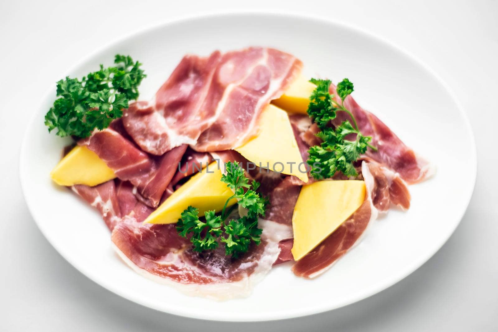 jamon serrano parma prosciutto style smoked ham with mango fruit starter tapas