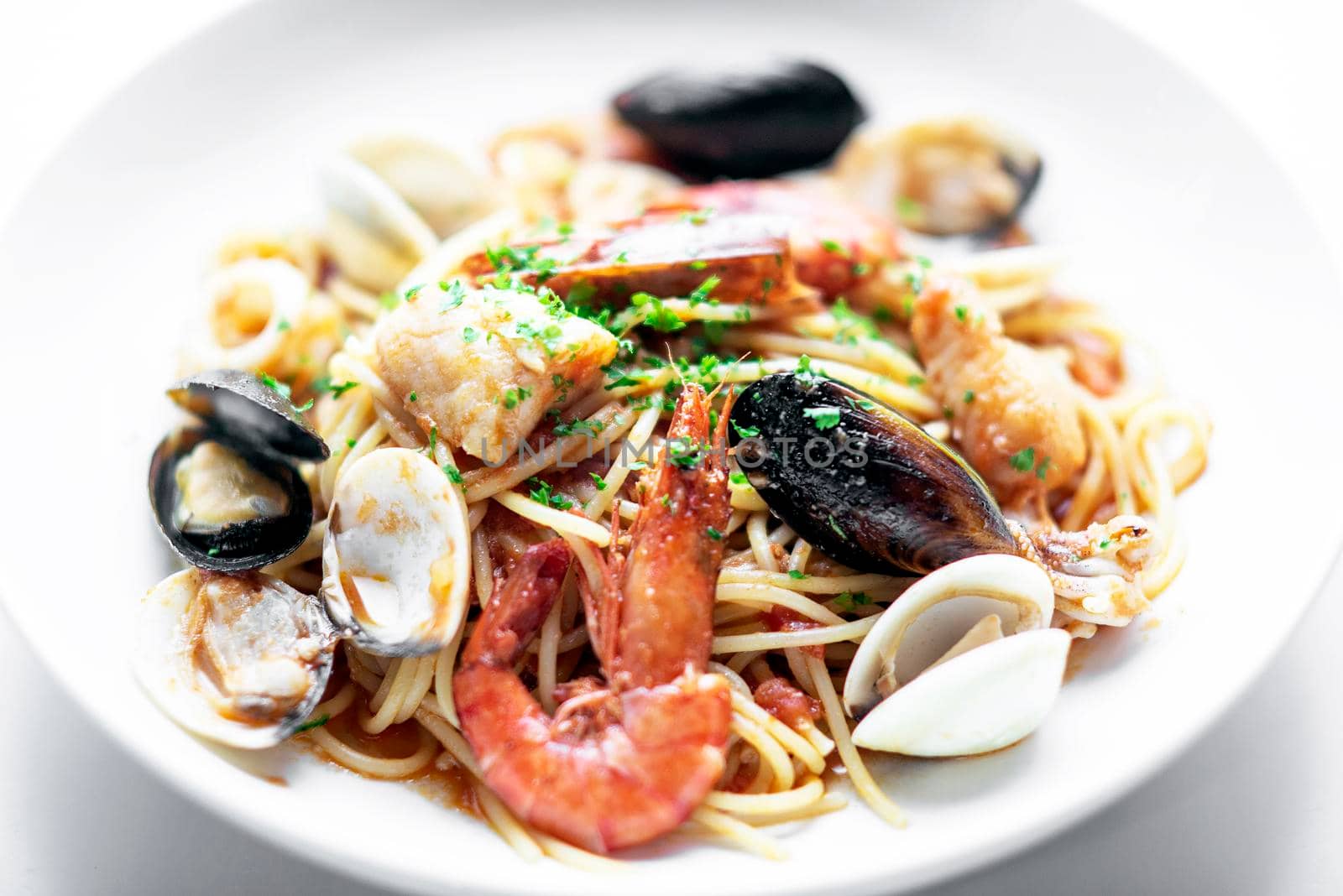 mixed seafood spaghetti pasta with prawns mussels scallops and clams by jackmalipan