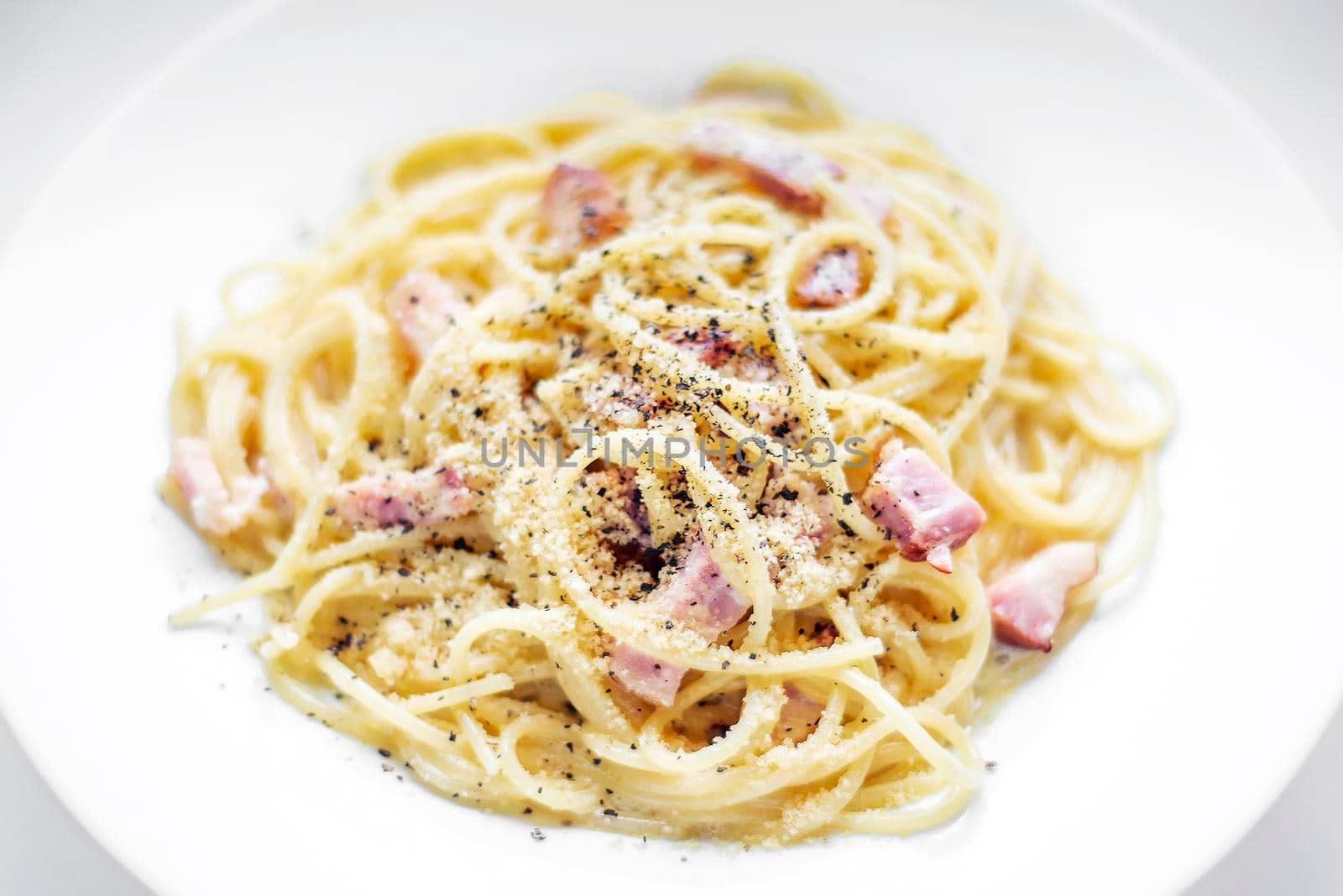 spaghetti pasta carbonara with bacon ham cream and kampot pepper by jackmalipan