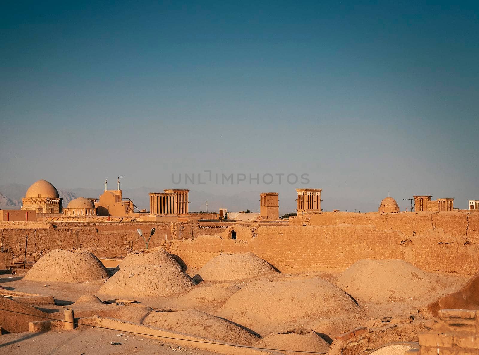 downtown rooftops wind towers and landscape view of yazd city old town in iran