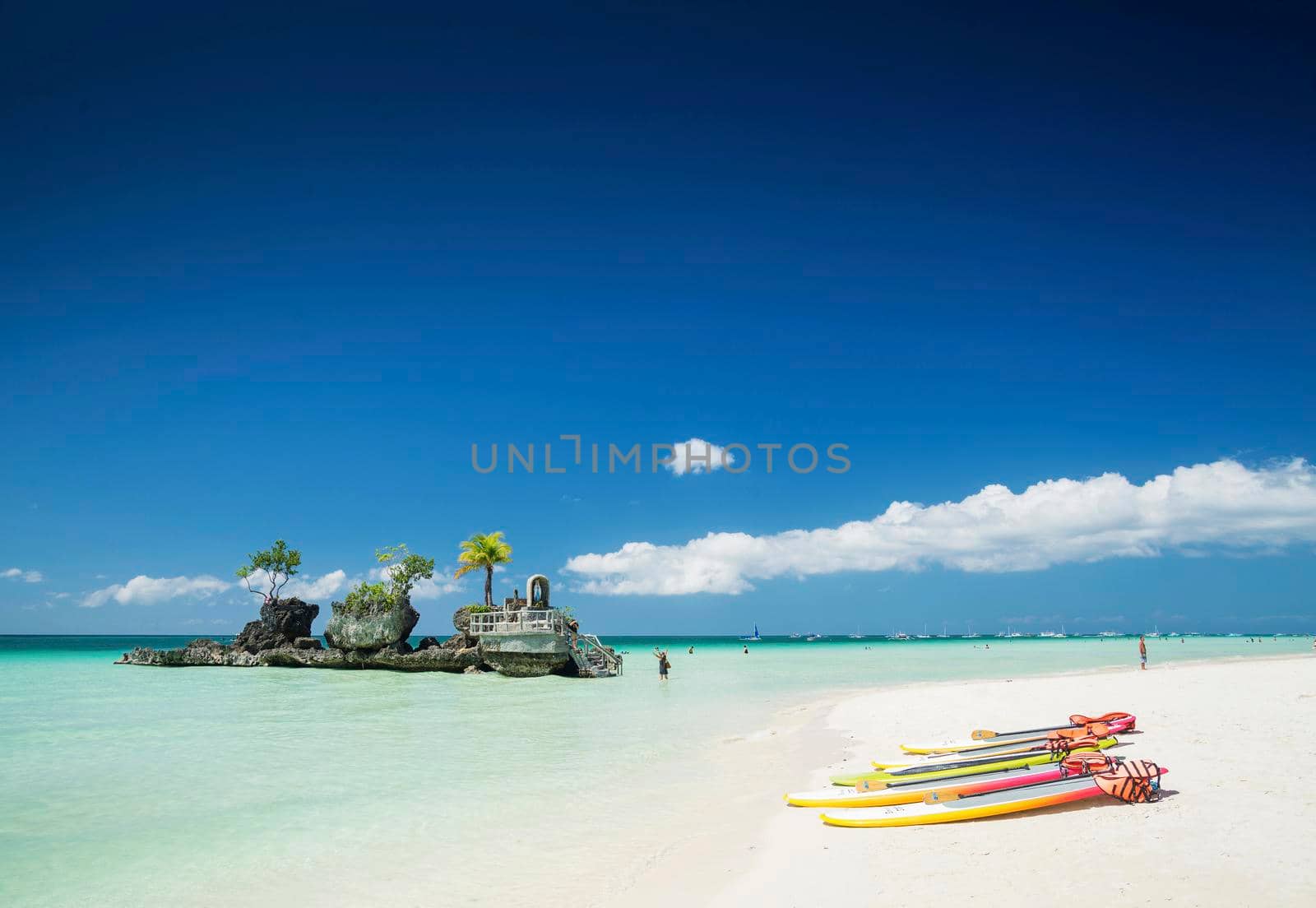 white beach and christian shrine and paddle boats on boracay tropical island in philippines asia