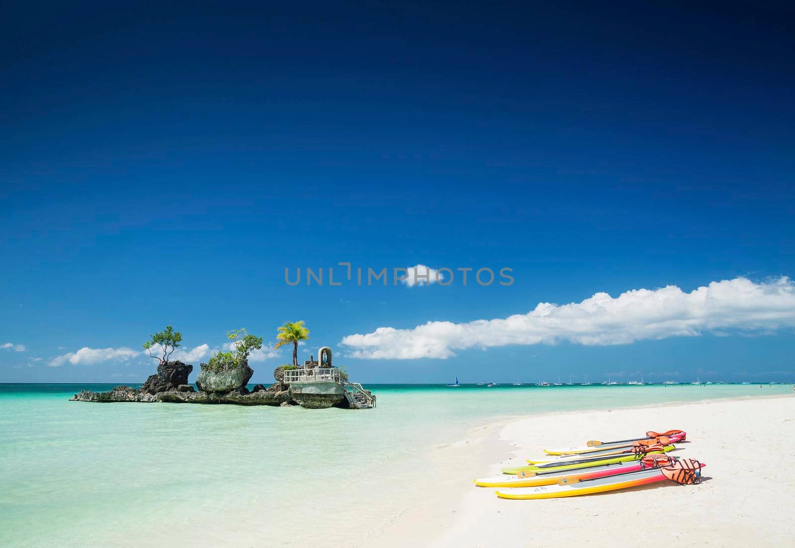 white beach and christian shrine and paddle boats on boracay tropical island in philippines by jackmalipan