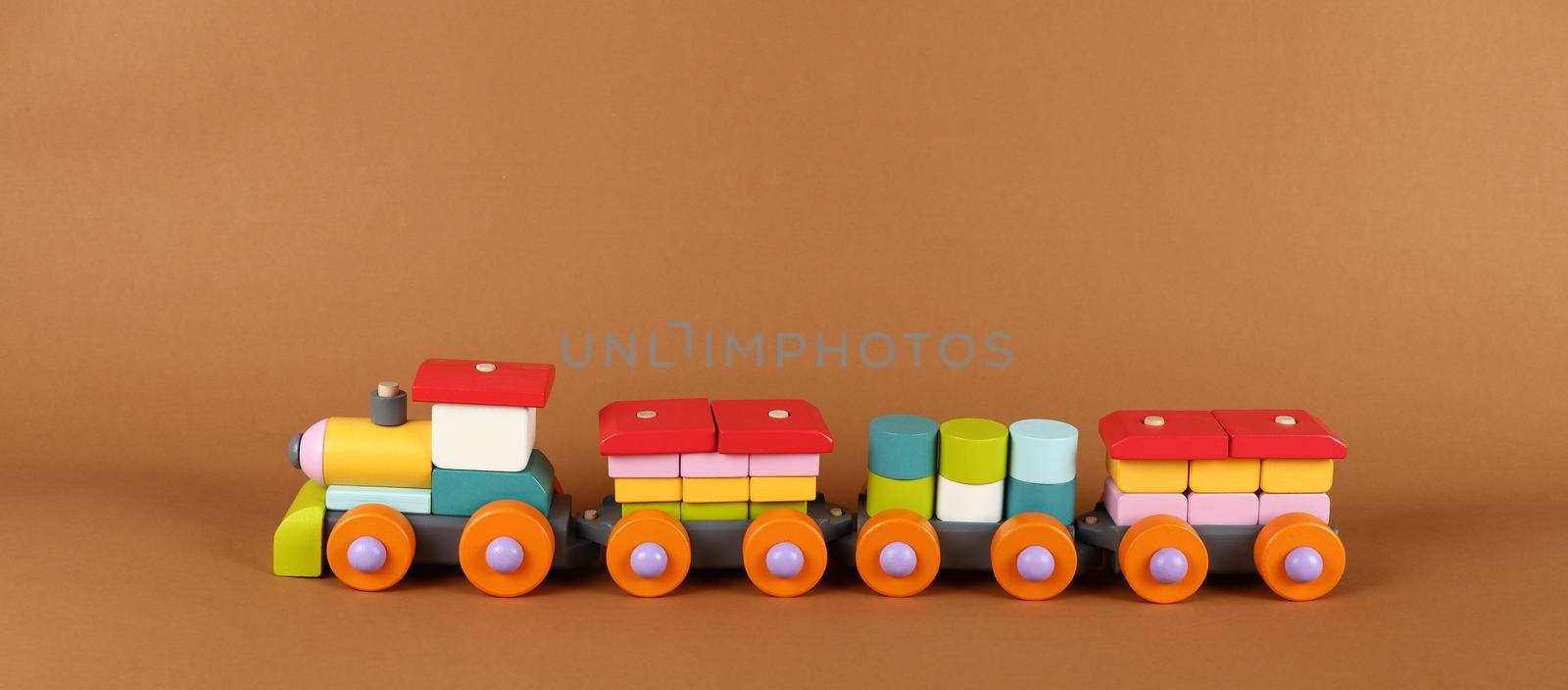 Wooden painted toy train over brown paper by BreakingTheWalls