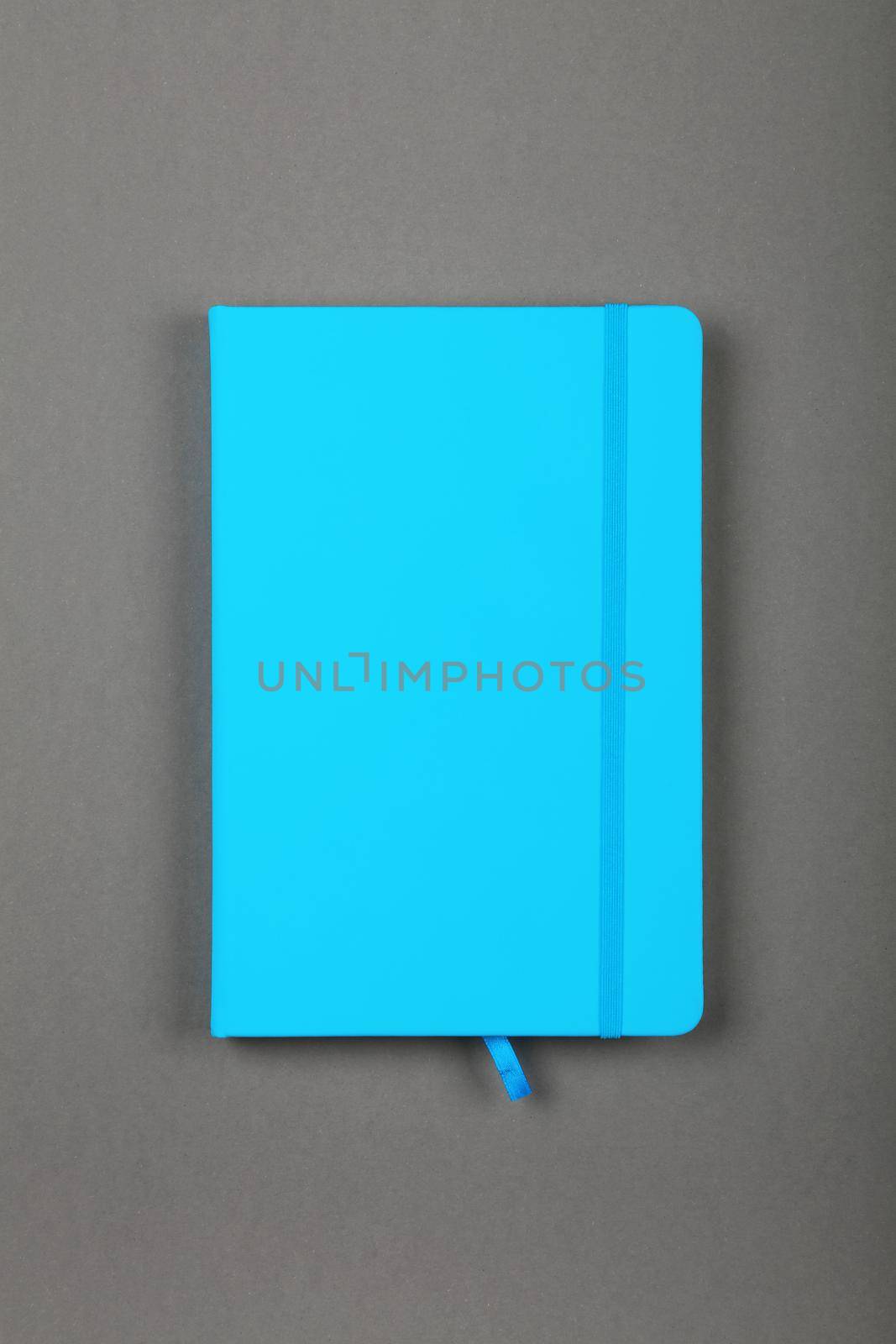Blue leather cover notebook over grey by BreakingTheWalls