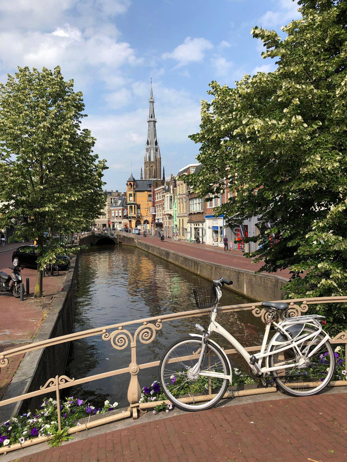 Bicycle on a canal bridge with the Sint-Bonifatiuskerk church in the background in Leeuwarden, Friesland The Netherlands