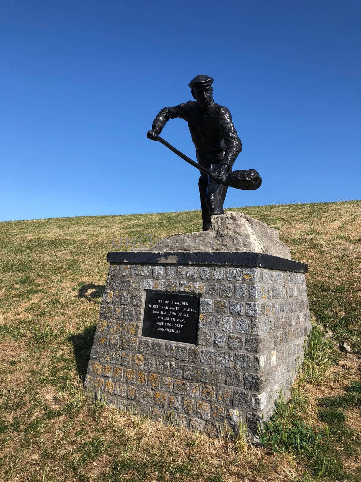 Statue on a dike at Zwarte Haan in Friesland The Netherlands