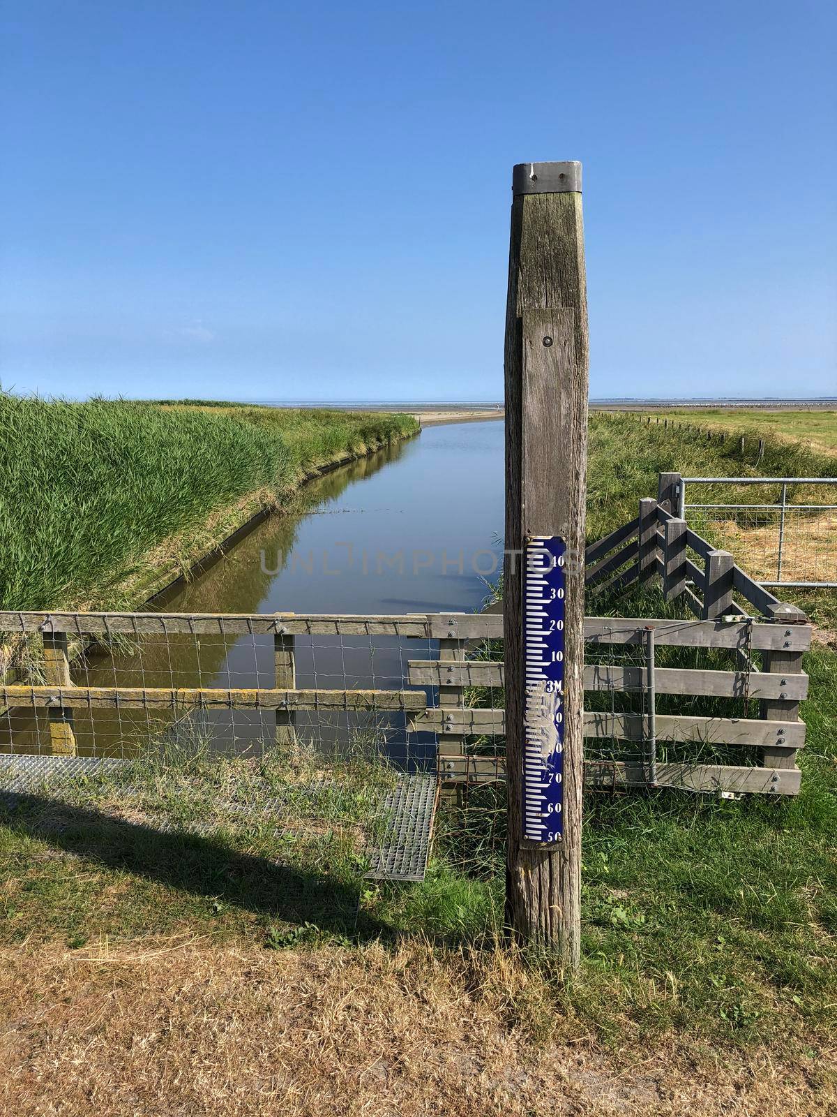 A meter to measure the water level on a dike in Zwarte Haan, Friesland The Netherlands