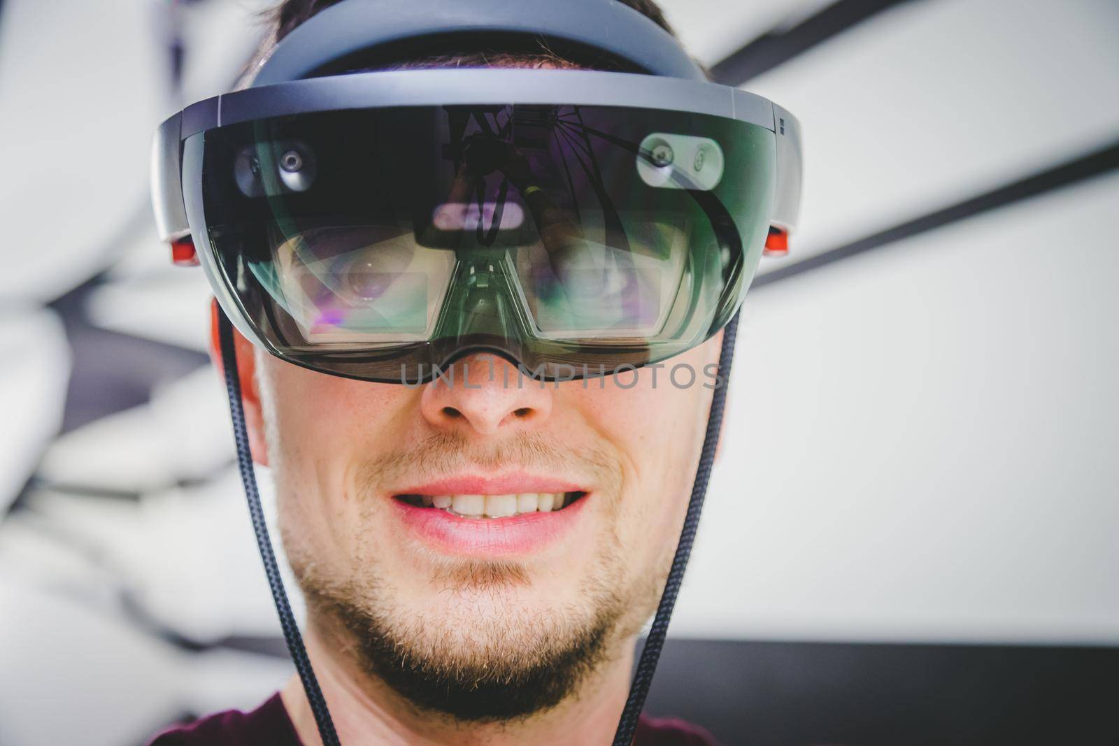 Young man wearing high end virtual reality glasses. Concept for VR, future, gadgets and technology. by Daxenbichler