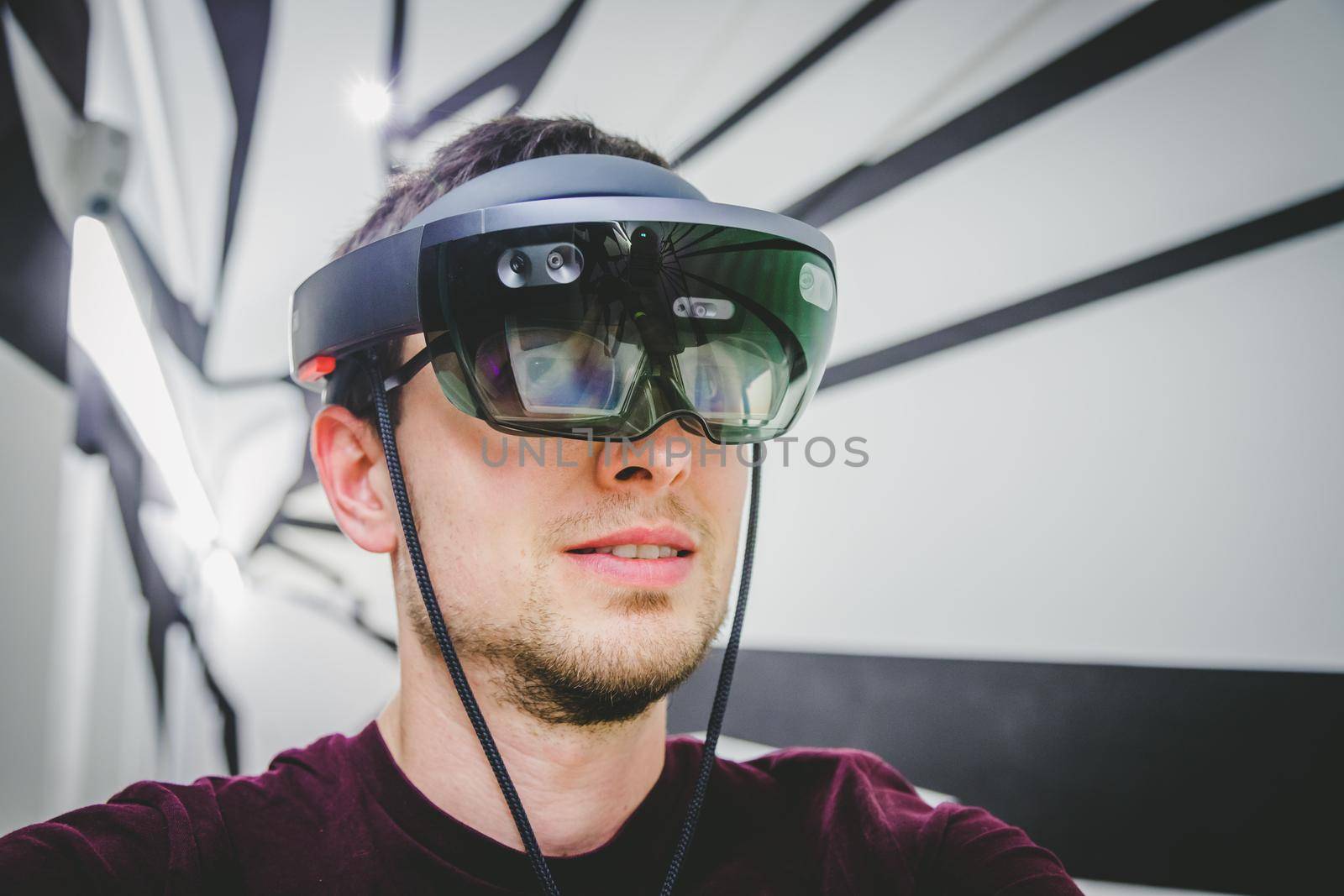 Young man wearing high end virtual reality glasses. Concept for VR, future, gadgets and technology. by Daxenbichler