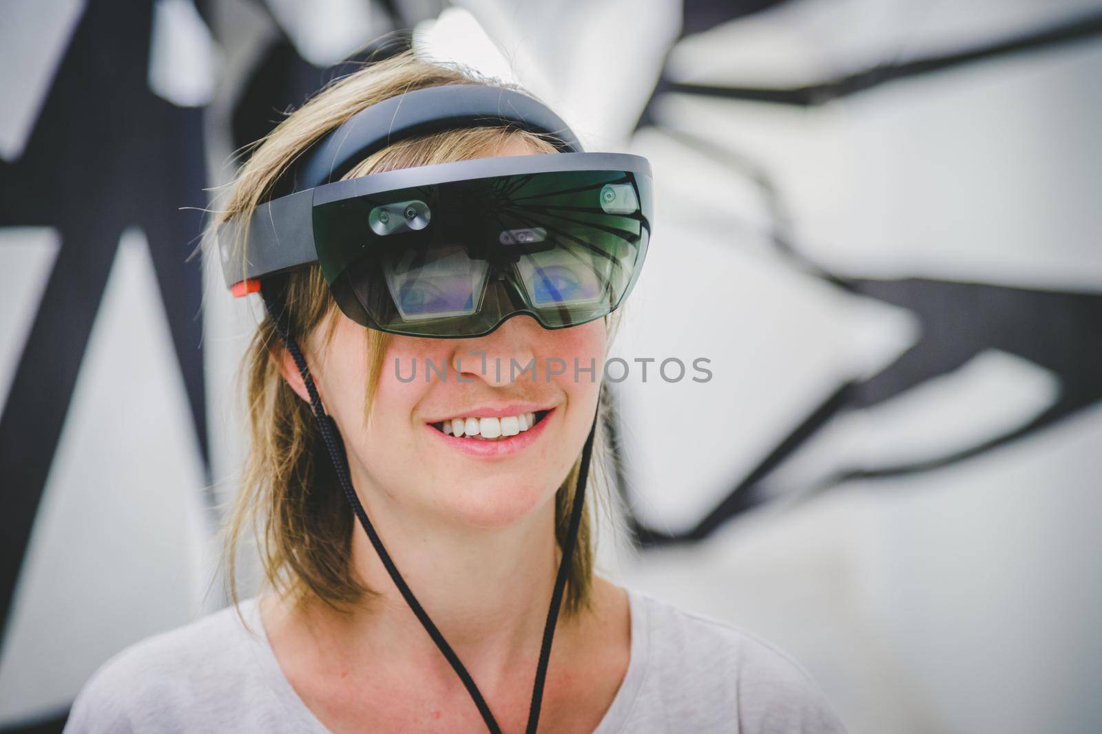 Young woman wearing high end virtual reality glasses. Concept for VR, future, gadgets and technology. by Daxenbichler