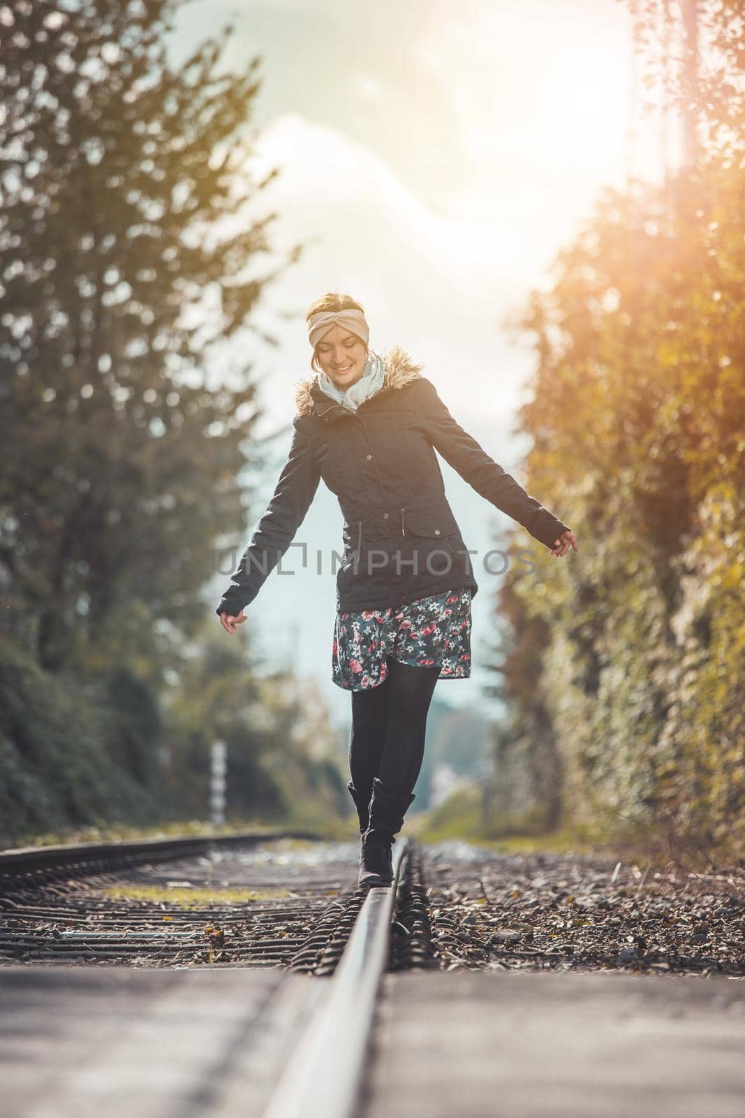 Girl waking on abandoned railroad, autumn