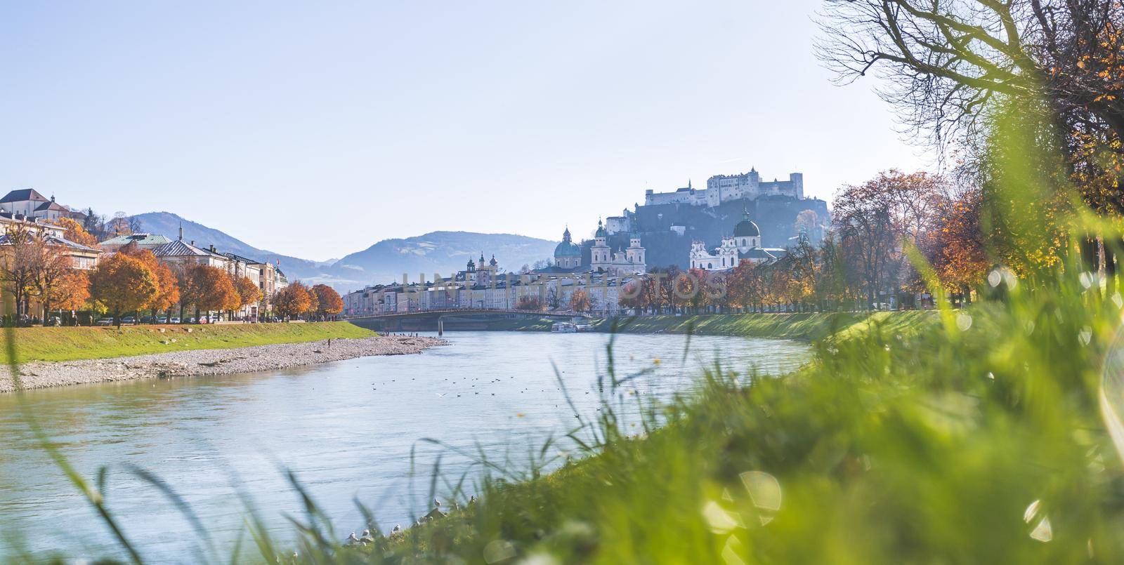 Salzburg historic district and the river salzach in autumn time, colorful leaves and colors with sunshine, Austria