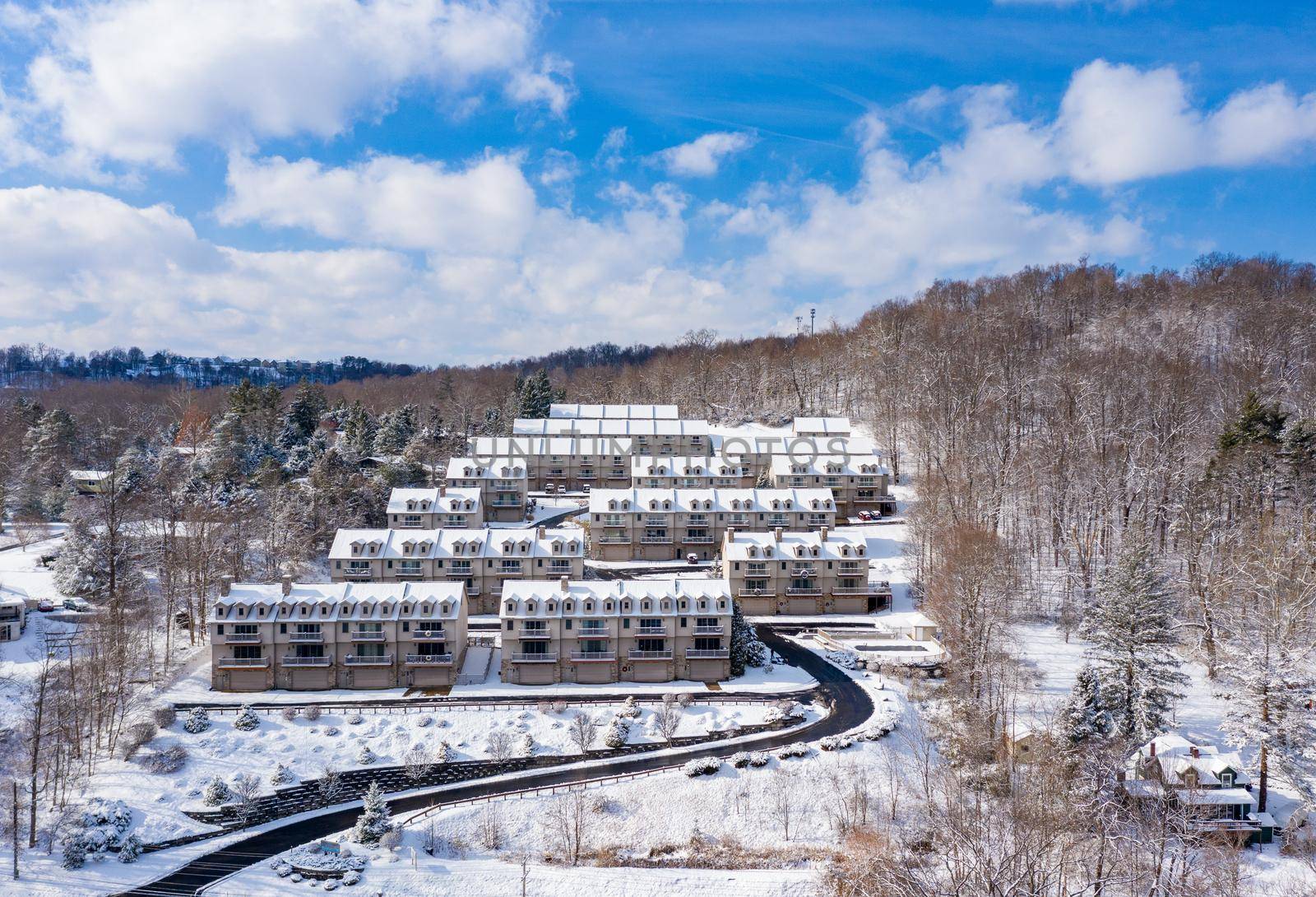 View of modern townhouses covered with winter snow on hill overlooking Cheat Lake near Morgantown West Virginia