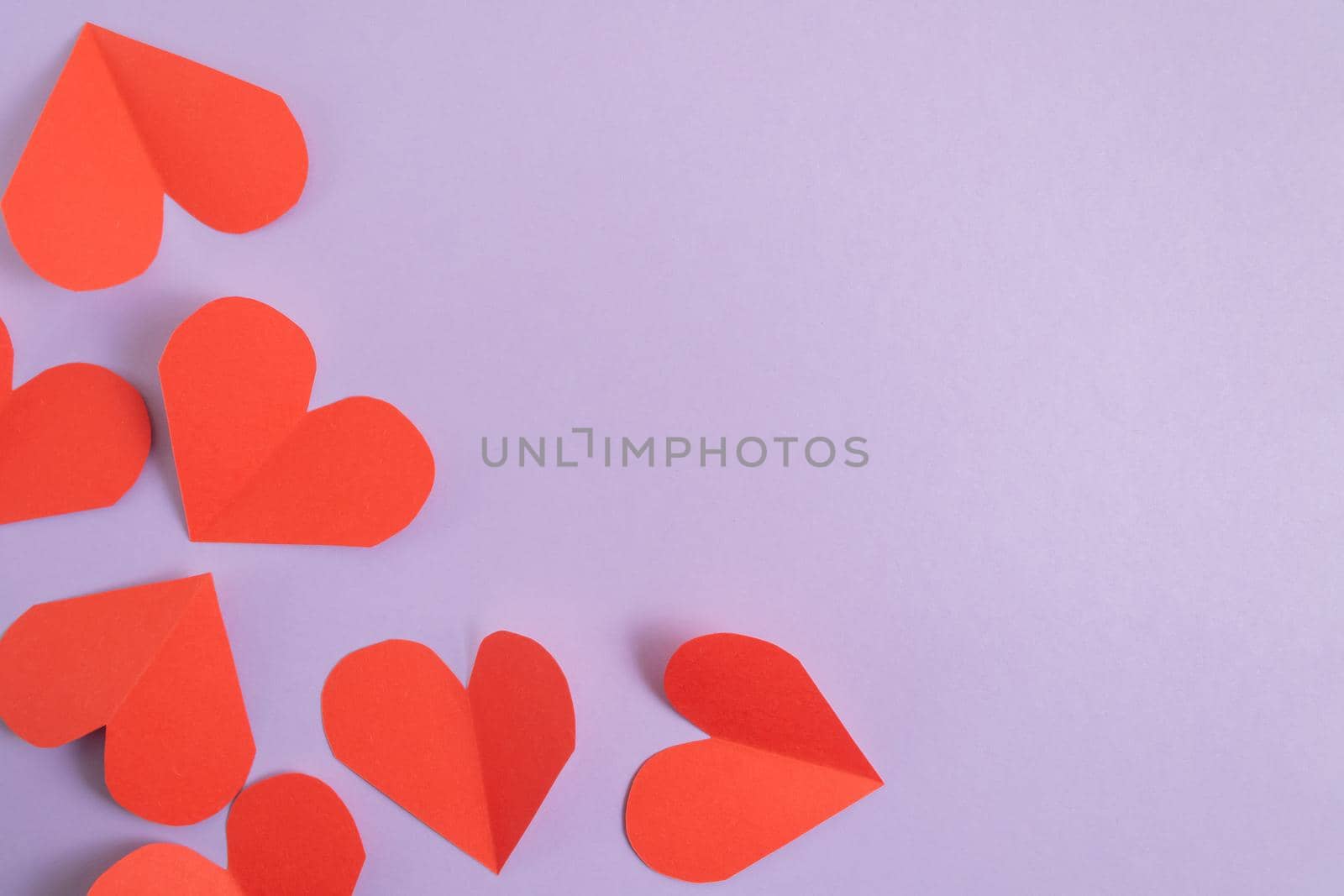 Valentine's Day background. Pink and red hearts on a pastel purple background. Valentine's Day concept. Layout for postcards and congratulations. Flat lay, top view, copy space by Alla_Morozova93