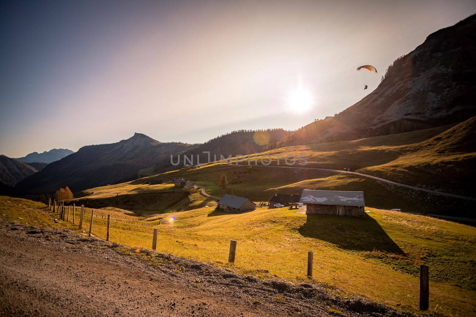 Beautiful scenic mountain scenery with huts and warm colors, sundown