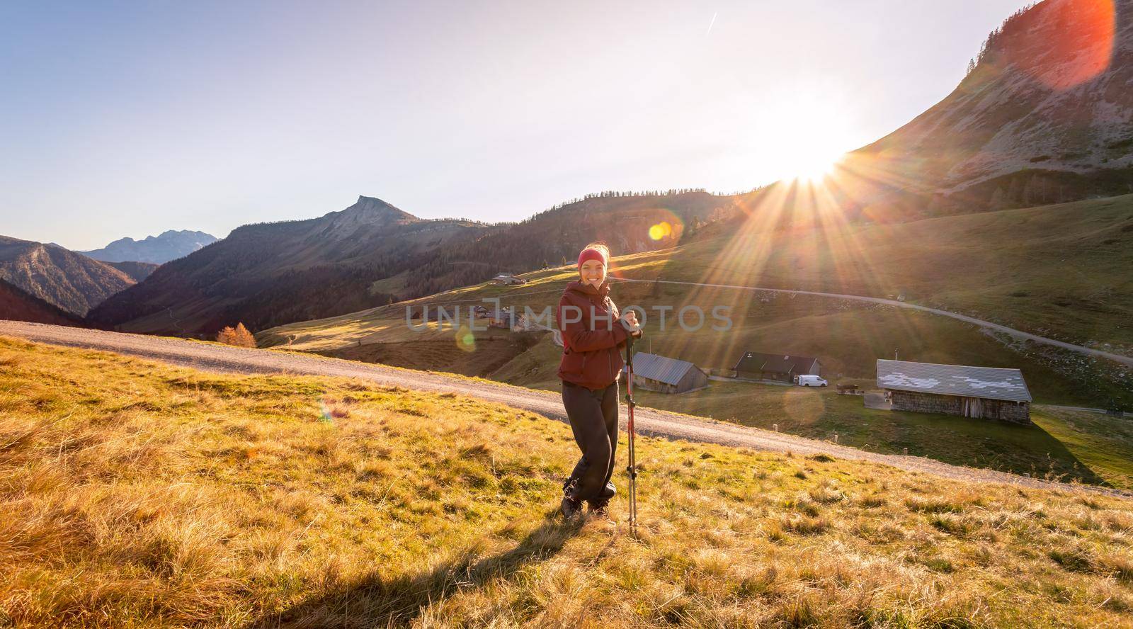 Hiking girl is enjoying the sundown in the mountains. Warm colors, alps, Austria by Daxenbichler