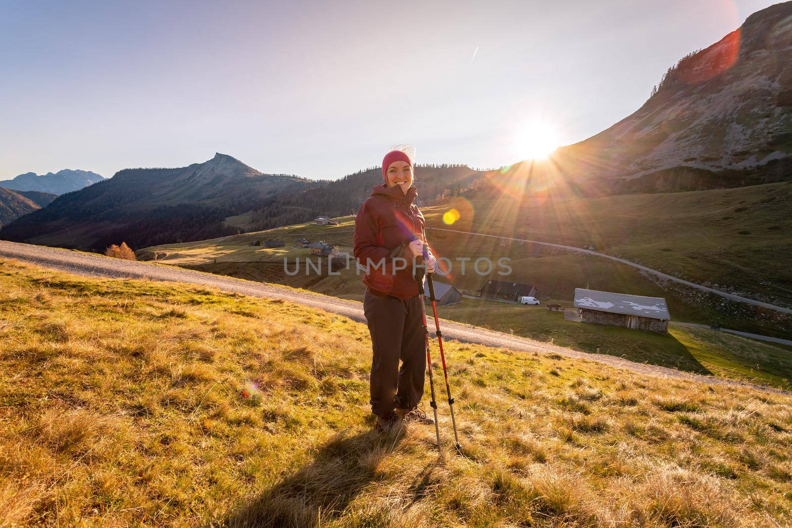 Hiking girl is enjoying the sundown in the mountains. Warm colors, alps, Austria by Daxenbichler