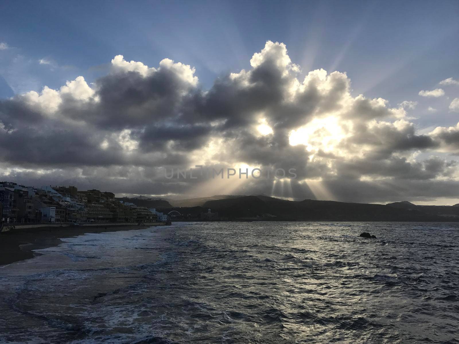 Sunshine shining through the clouds at Las Canteras in Las Palmas Gran Canaria