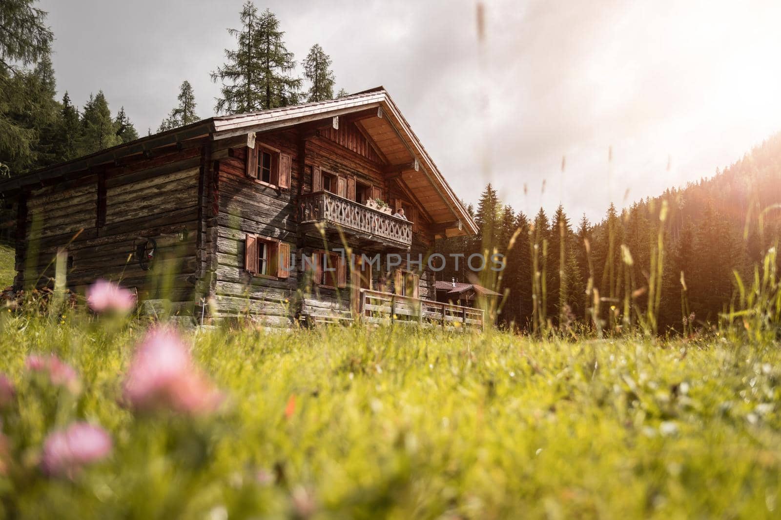 Mountain chalet and cloudy sky in Austria: Idyllic landscape in the Alps