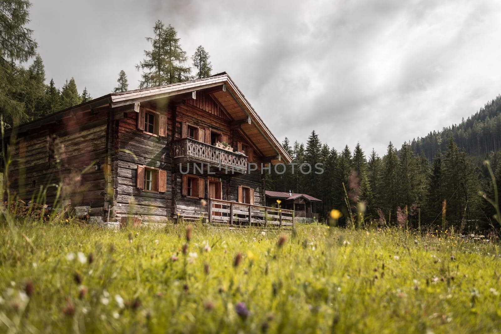 Mountain chalet and cloudy sky in Austria: Idyllic landscape in the Alps
