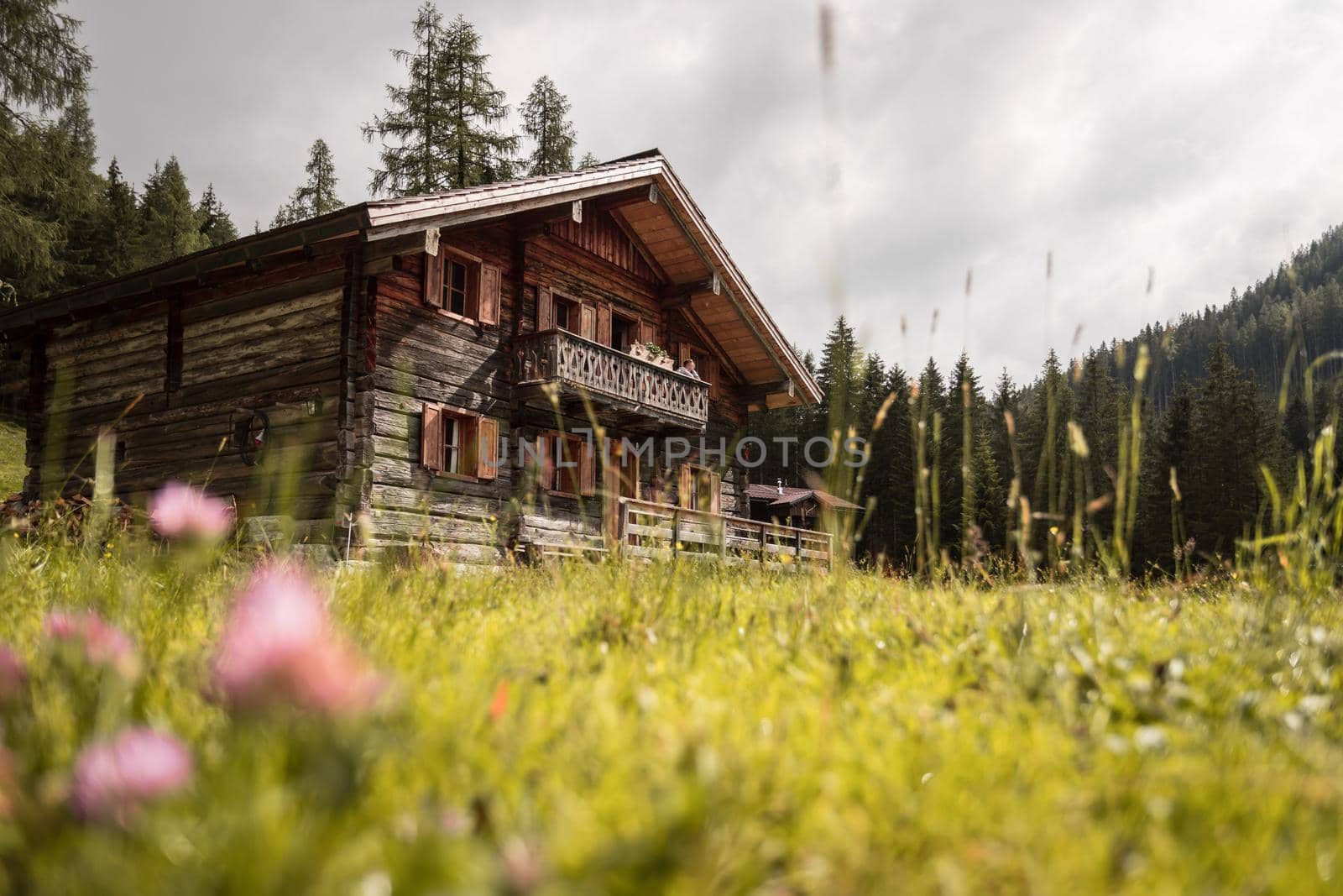 Mountain chalet and cloudy sky in Austria: Idyllic landscape in the Alps