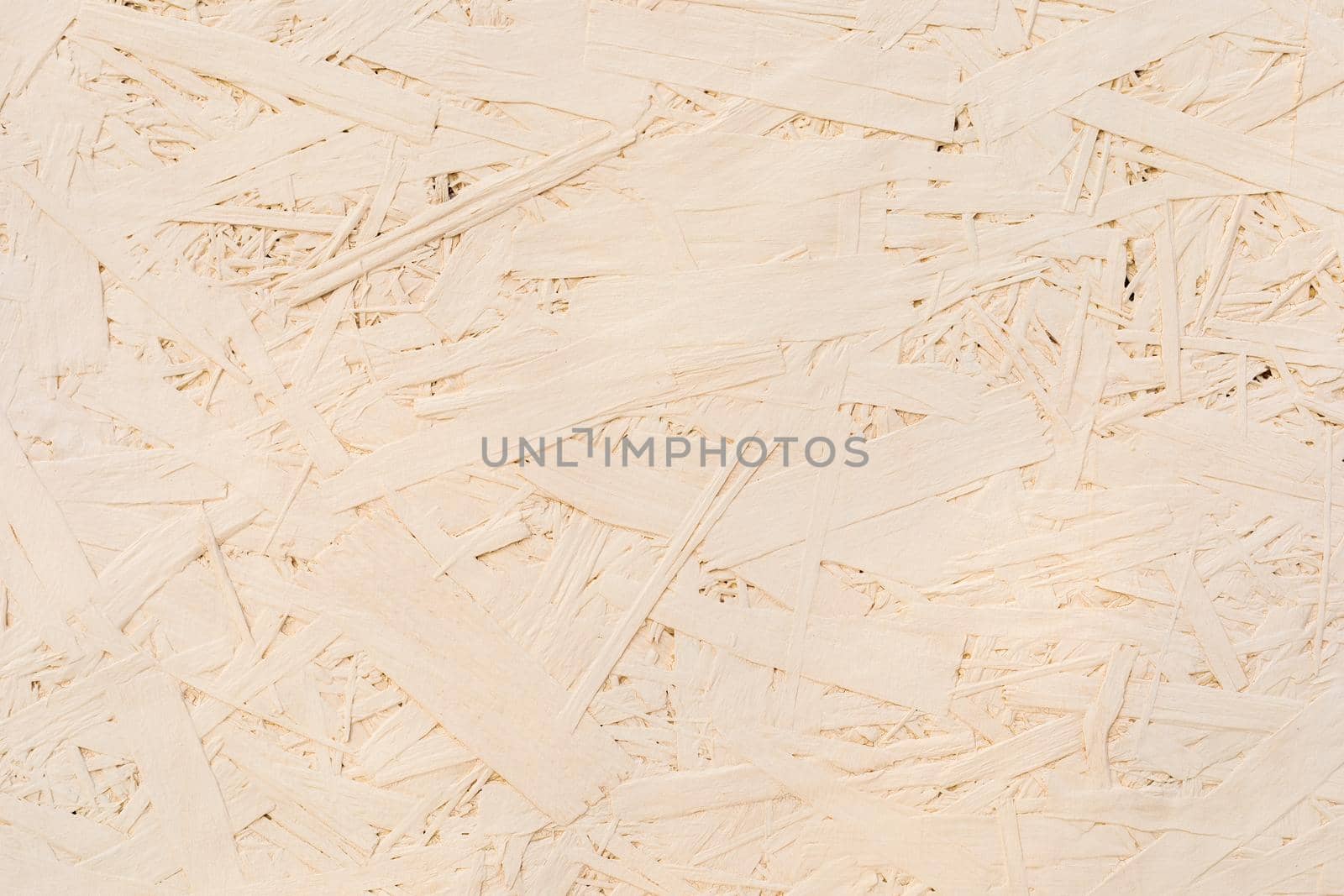 Fragments of glued boards from wood chips. Chipboard beige, wood texture. Wood recycling concept