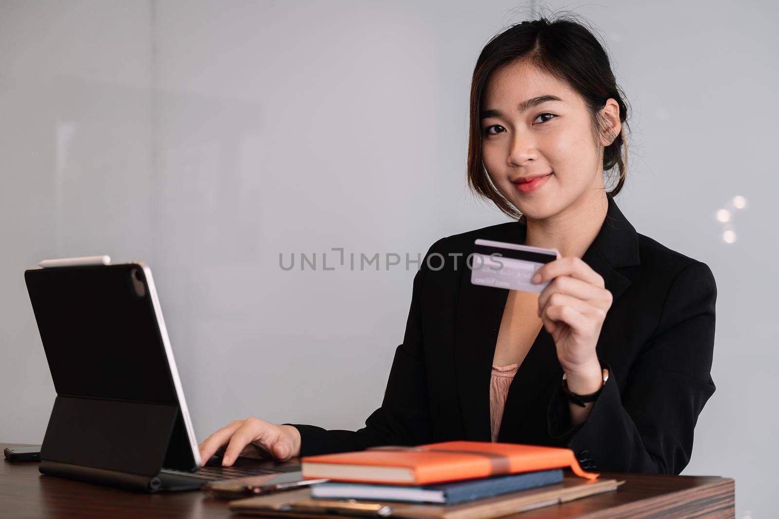 Busiesswoman holding creditcard and using laptop computer for online shopping, Online Payment, e-commerce, internet banking. by nateemee