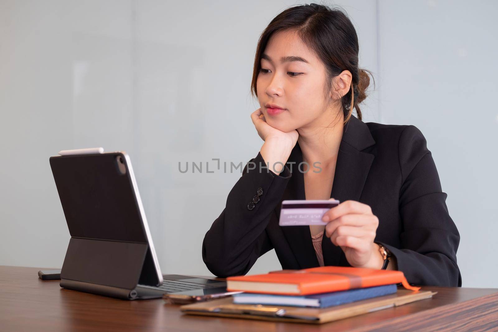 Busiesswoman holding creditcard and using laptop computer for online shopping, Online Payment, e-commerce, internet banking. by nateemee