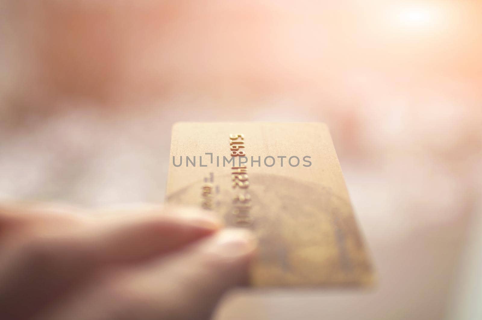 bank card of gold color in hands on a background by ozornina