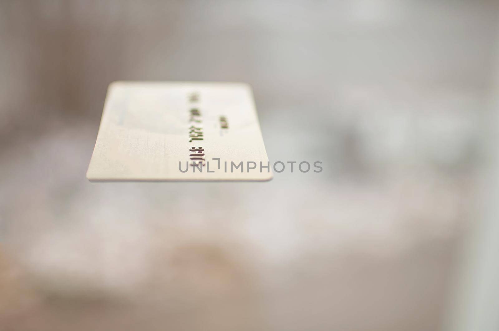 bank card of gold color on a background of beige color  by ozornina