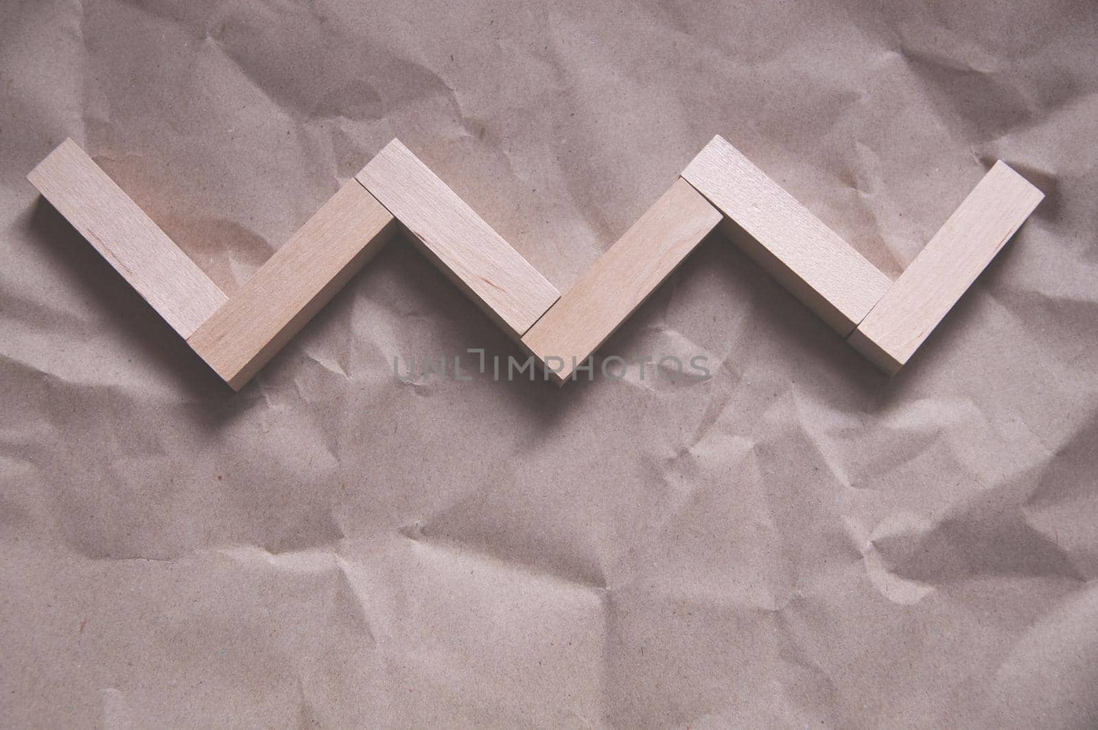 background of crumpled craft paper with wooden rectangles arranged in a certain order by ozornina