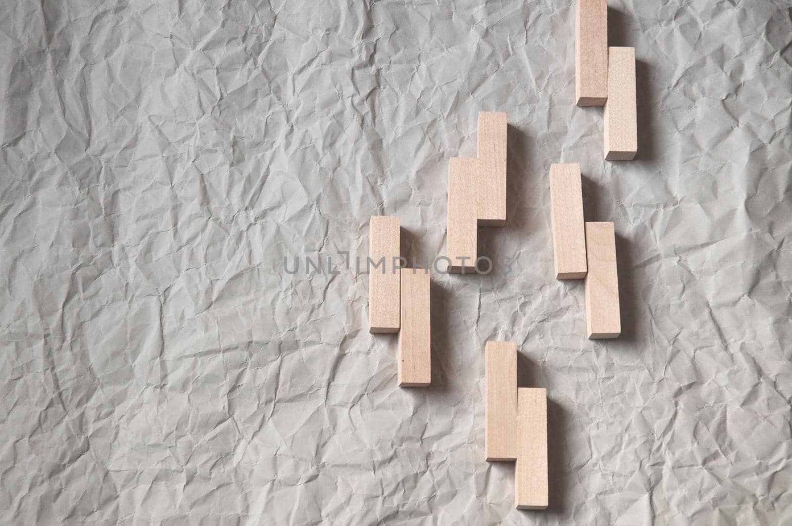 background of crumpled craft paper with wooden rectangles arranged in a certain order in a minimalist style