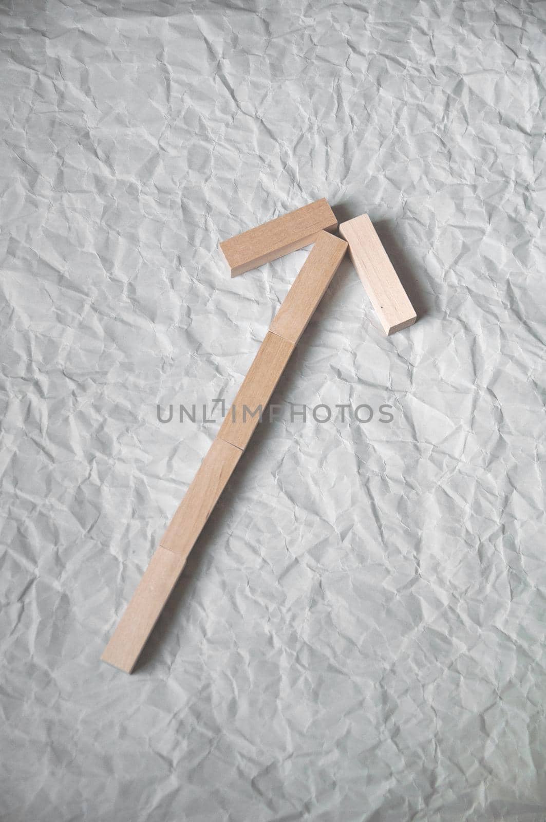 background of crumpled craft paper with wooden rectangles arranged in a certain order by ozornina