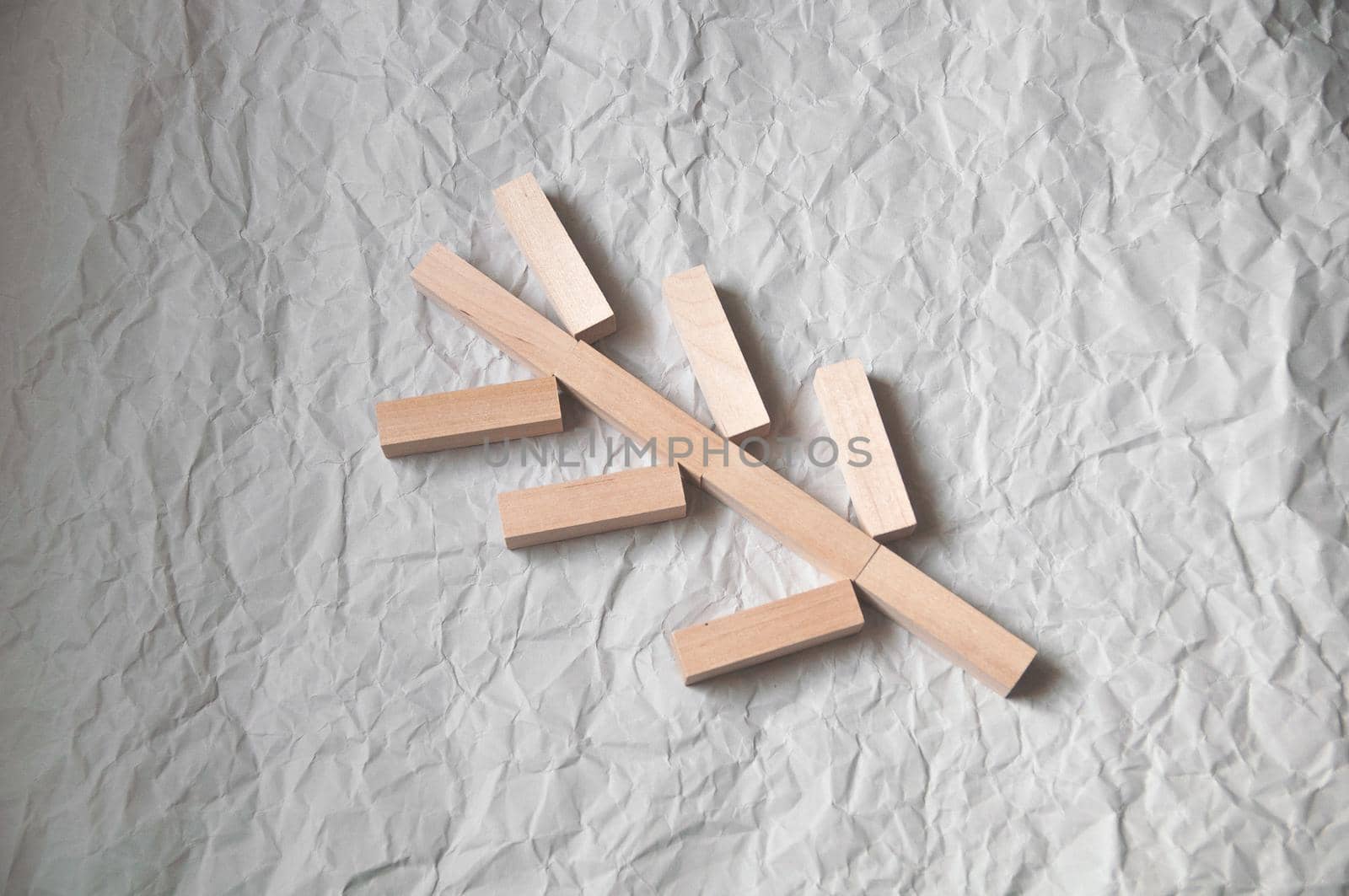 background of crumpled craft paper with wooden rectangles arranged in a certain order in a minimalist style