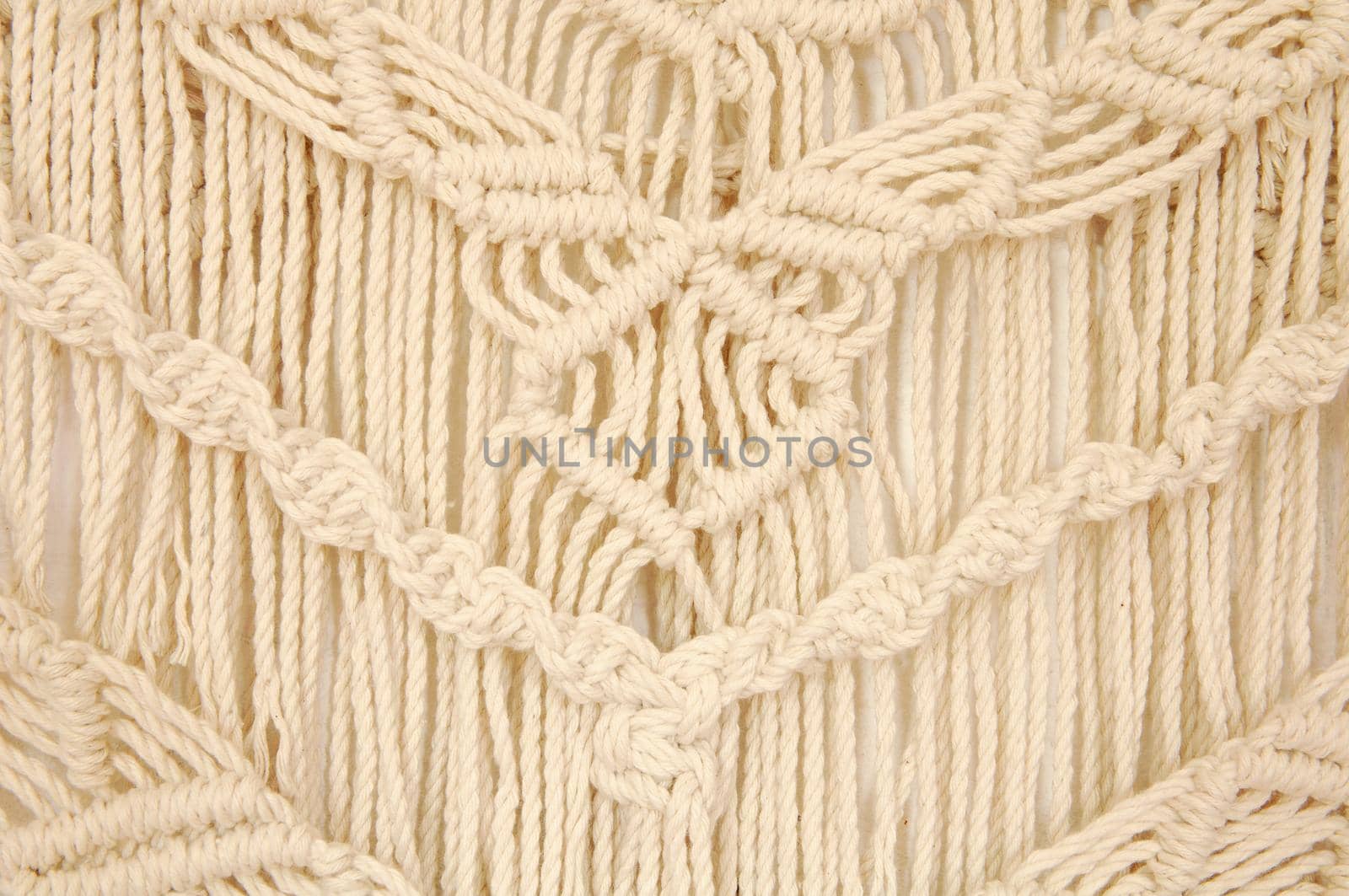 Macrame pattern. A minimal, stylish, trendy concept with a beautiful background with light neutral colors.