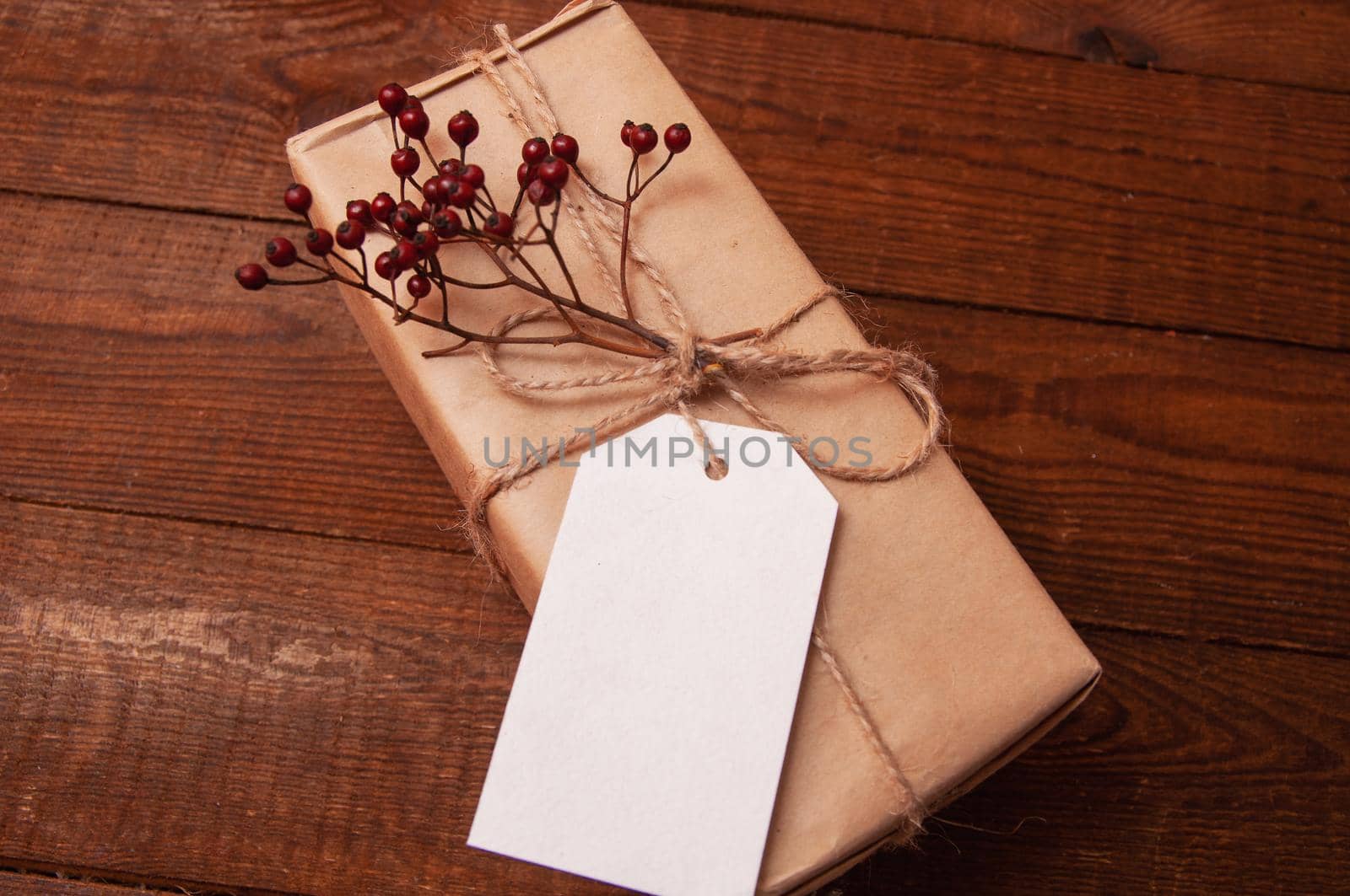 gift wrapped in craft paper on top of a flower tied with twine by ozornina