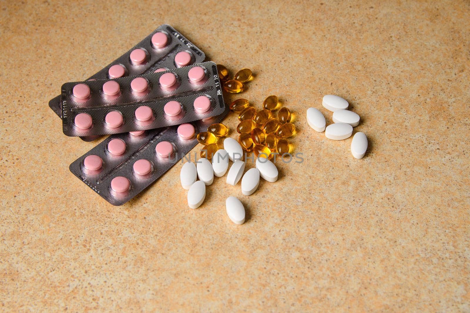 capsules on a table with a pattern of sand by ozornina