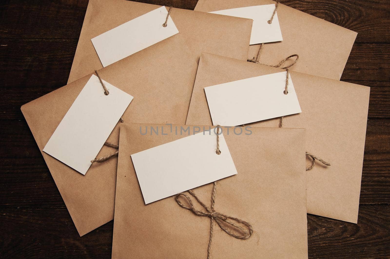 Note from a paper on a card of an envelope from kraft paper on a wooden table