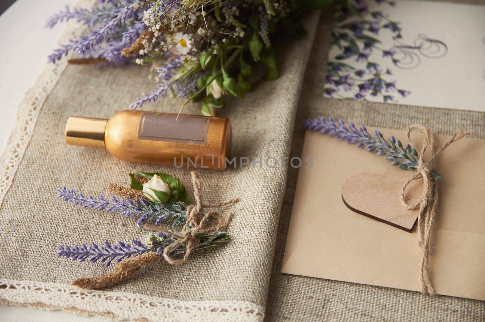 boho style wedding envelope on table with lavender flower