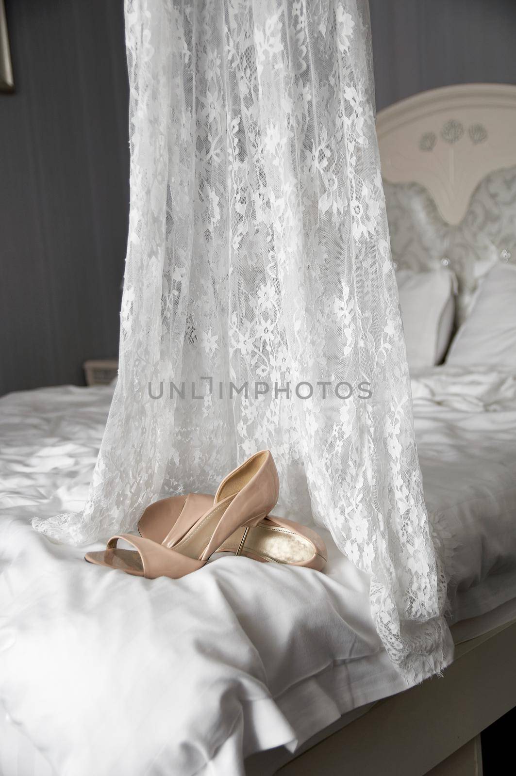 wedding shoes on the bed next to the dress by ozornina