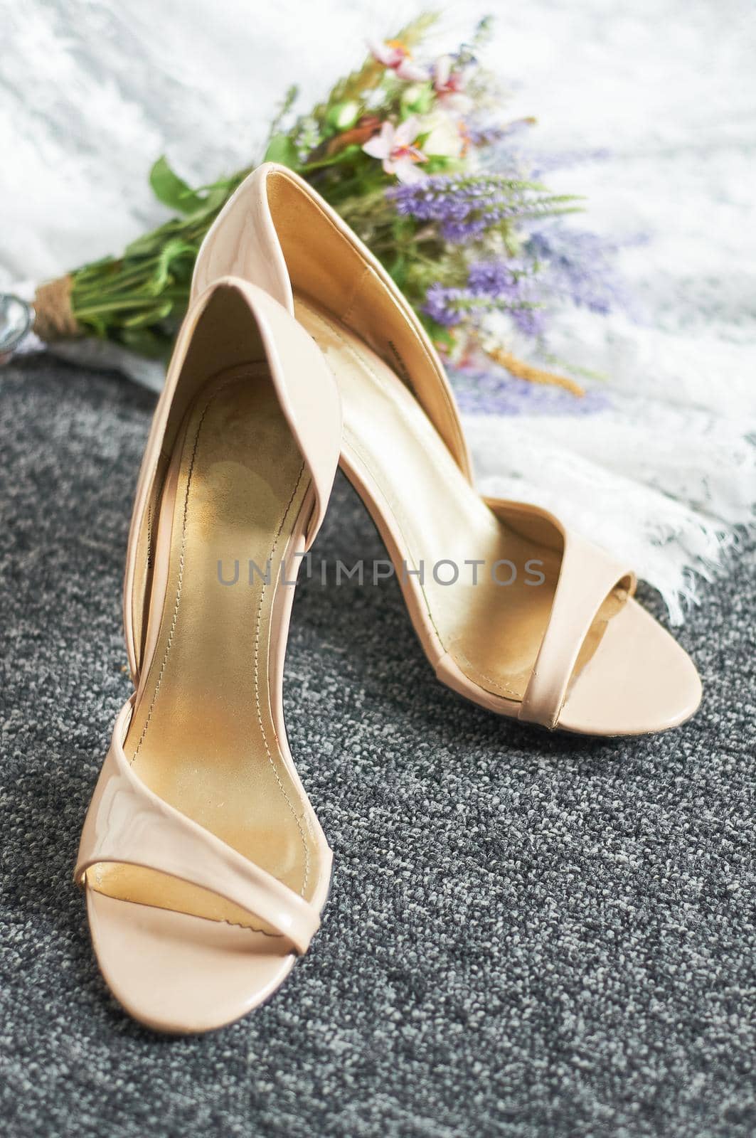 wedding shoes on the rug next to the bridal bouquet by ozornina