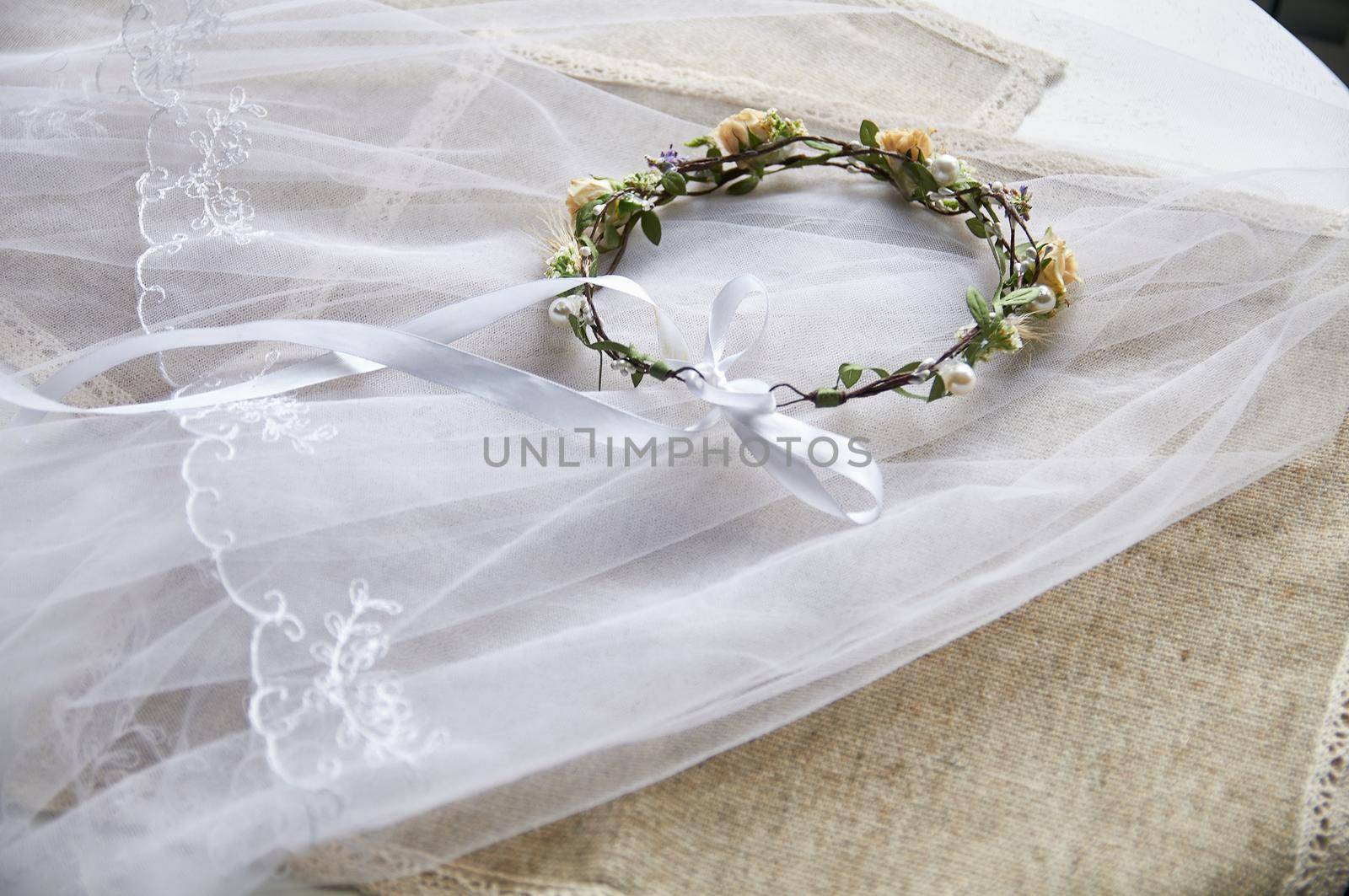 wedding wreath on table with lavender bridal bouquet