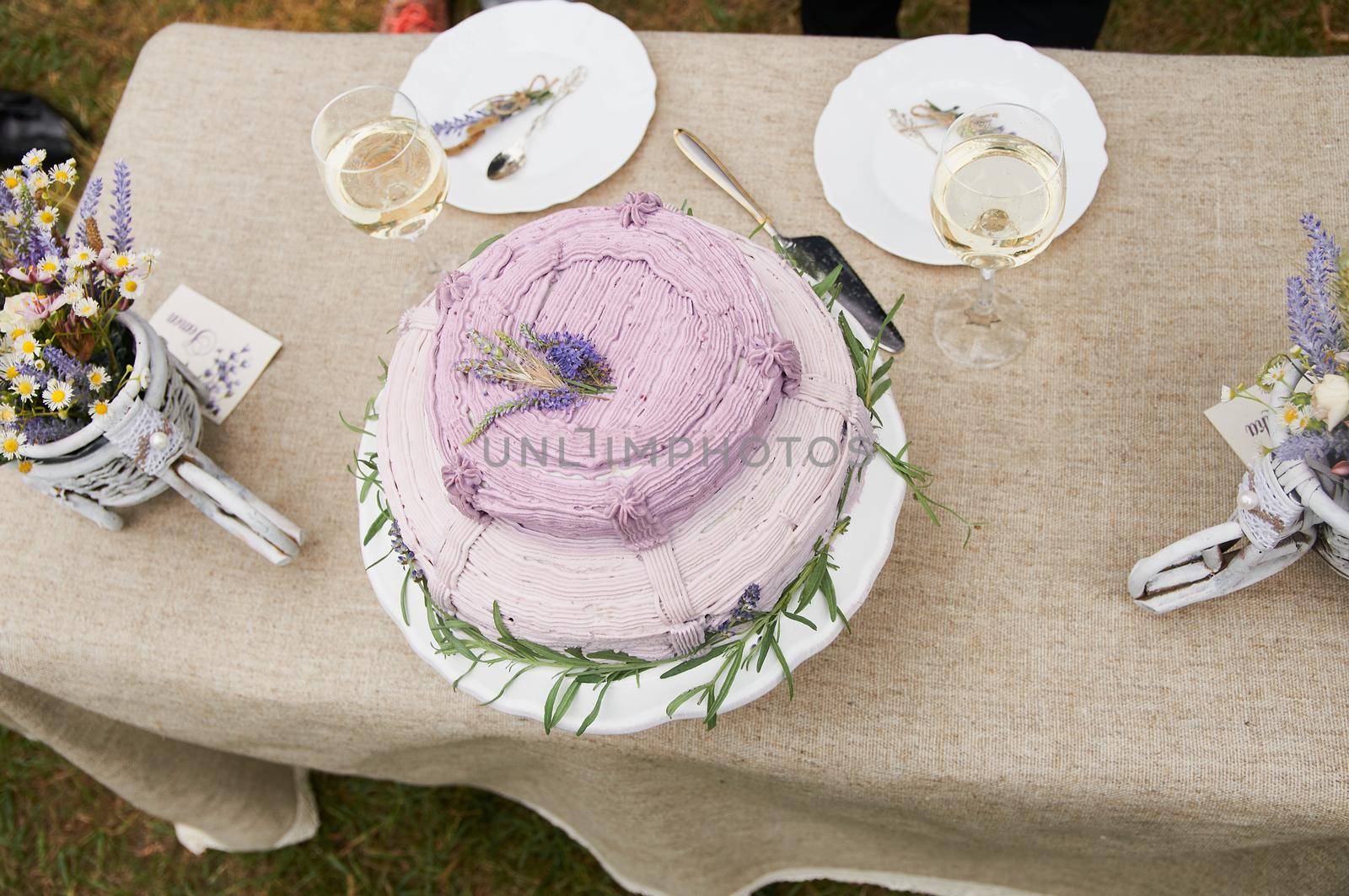 covered with a linen tablecloth, with plates, glasses, knife by ozornina