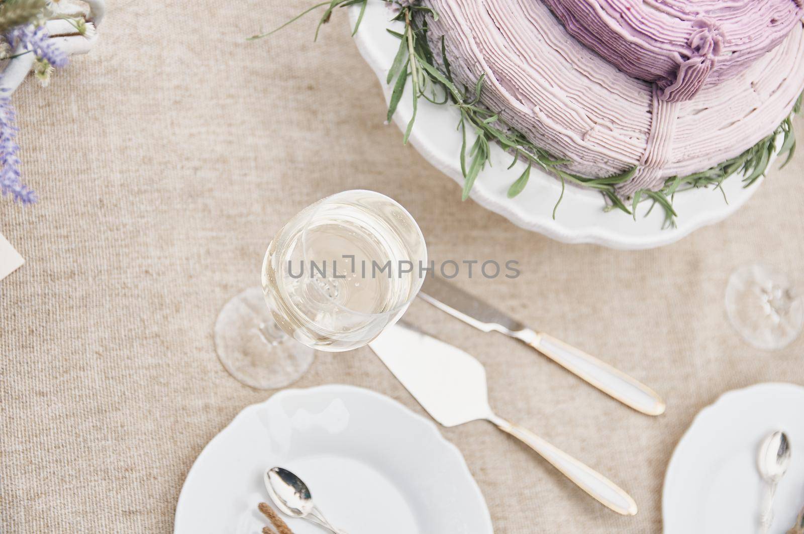 covered with a linen tablecloth, with plates, glasses, knife by ozornina