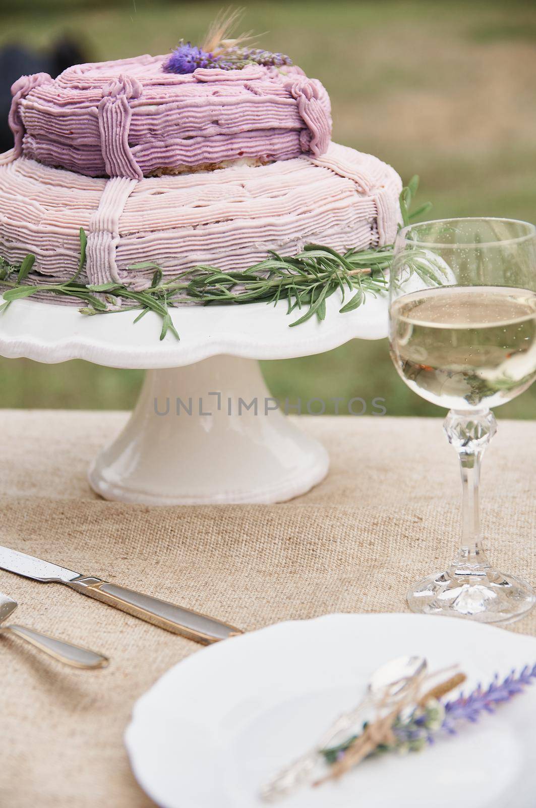 rustic style butter cake on a festive table with a glass  by ozornina
